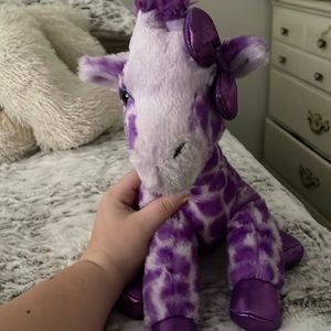 Purple giraffe with bow stuffed animal